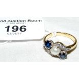 An 18ct yellow gold diamond, sapphire and pearl ring in crossover setting