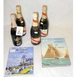 Four bottles of Mumm's "Admiral's Cup Reserve" champagne, together with two volumes of Cowes