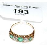 An 18ct yellow gold emerald and diamond five stone ring