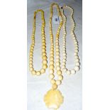 Three strings of graduated ivory beads - one with carved flower pendant