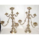 A pair of 50cm high continental embossed, engraved and plated four branch candelabra