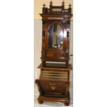 A walnut cased "penny in the slot" symphonion on fall front storage stand containing nine 48.5cm