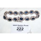 A sapphire and diamond oval cluster link bracelet with 14 oval shaped brilliant cut blue