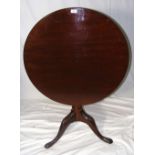 A 74cm diameter Georgian mahogany "bird cage" tripod table on reeded column and carved Acanthus