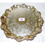 A 27cm diameter Victorian chased and engraved silver salver with shaped gadrooned rim by James