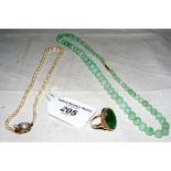 An apple jade graduated bead necklace with gold clasp, a pearl necklet and a 9ct gold oval jade