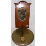 A 36cm diameter brass dinner gong, the oak support mounted with ornately cast bronze Boar's head