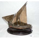 A 27cm high white metal Nef, in the form of a Dhow, on wooden base