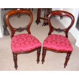 A set of six reproduction Victorian mahogany dining chairs with overstuffed serpentine seats, turned