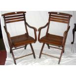 A pair of beech folding steamer chairs with slatted seats and back rests