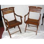 A pair of beech folding steamer chairs with slatted seats and back rests