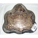 "Toogood Championship Shield" - embossed silver plaque with lion surmount mounted on velvet base