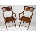 A pair of beech folding steamer chairs with slatted seats and back rests