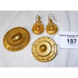 A Victorian "Target" brooch and the matching pair of earrings, together with one other "Target"