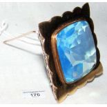A 9ct gold brooch mounted with large blue stone