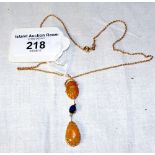An 18ct gold fire opal and sapphire pendant and chain