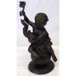 A bronze figure of a cherub seated on a globe and holding a stylized dolphin - 79cm high overall