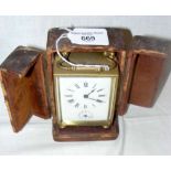 A French brass cased carriage clock with leather carrying case