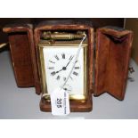 A French brass cased carriage clock with leather carrying case