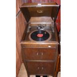 An HMV oak cased gramophone with records