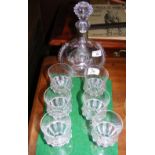 An ornate glass decanter with the matching set of six glasses