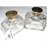 A pair of silver mounted cut glass cologne bottles