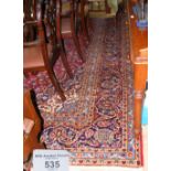 A large Middle Eastern style carpet, having geometric border and centre medallions - 420cm x 296cm