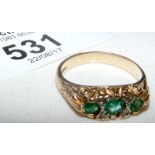 Diamond and emerald ring in gold setting