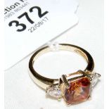 A three stone dress ring in 9ct gold setting