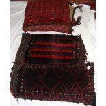 Two antique Middle Eastern saddle bags converted to pillows, together with one other Middle