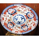 A large antique Imari charger with bird and floral decoration - 46cm diameter