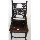 An antique carved Chinese hardwood side chair - the backrest and legs with carved foliate design