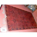 UPSTAIRS - Middle Eastern style carpet with red ground and geometric border - 210cm x 122cm