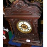 An antique wooden cased mantel clock