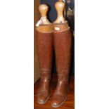 A pair of old riding boots with wooden stretchers