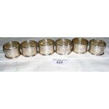 Cased set of six engine turned silver napkin rings with Birmingham marks