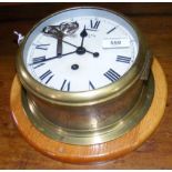 A Smith 8 Day ship's brass cased bulkhead clock - 19cm diameter