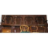 A set of four Chippendale style dining chairs with carved backrests