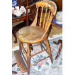 An antique school teacher's chair with turned back support