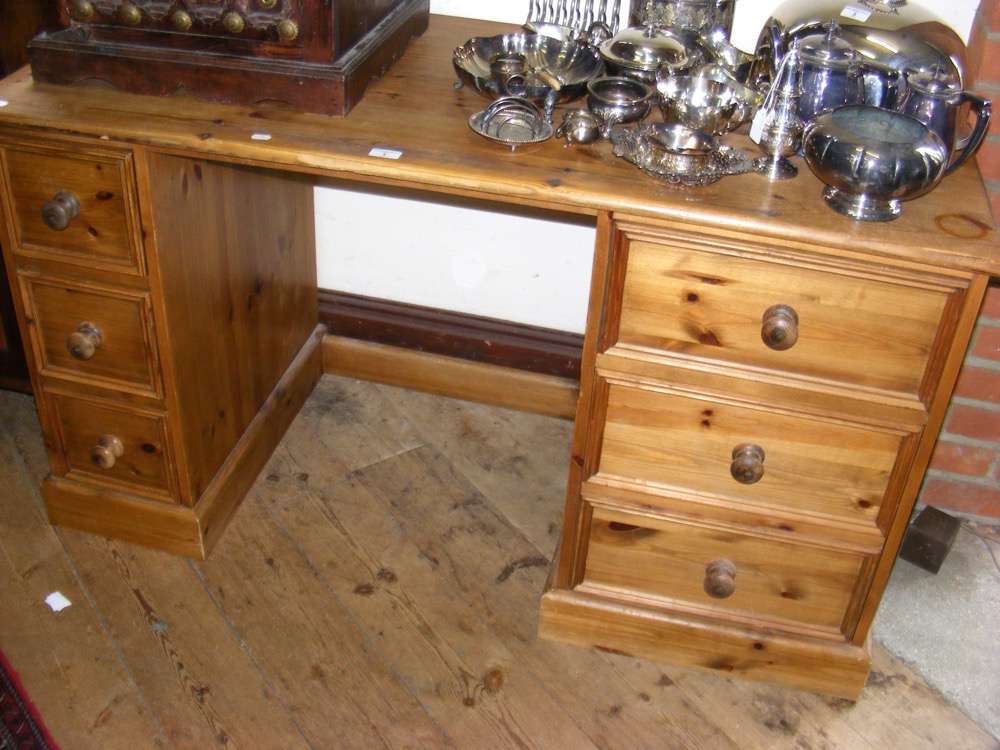 Pine kneehole desk with six drawers to the pedestals