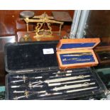 Set of brass postal balance scales and two cased sets of drawing instruments