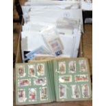 An album containing cigarette cards, together with a large quantity of collectable stamps