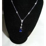 A sapphire and diamond set pendant with diamond set chain