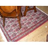 A 150cm x 100cm beige/red Middle Eastern rug