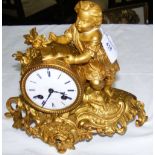 A 25cm high ormolu cased striking mantel clock with figural mount