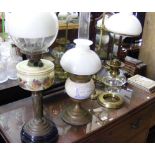 Four assorted early oil lamps