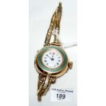 A 9ct gold cased lady's wrist watch with green enamel decoration and 9ct gold expanding bracelet