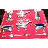 A cased six piece silver condiment set, complete with spoons