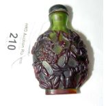 An old Chinese green glass, with red overlay, snuff bottle, having ivory spoon and green glass top -
