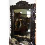 A decorative carved wooden mirror - 90cm x 60cm